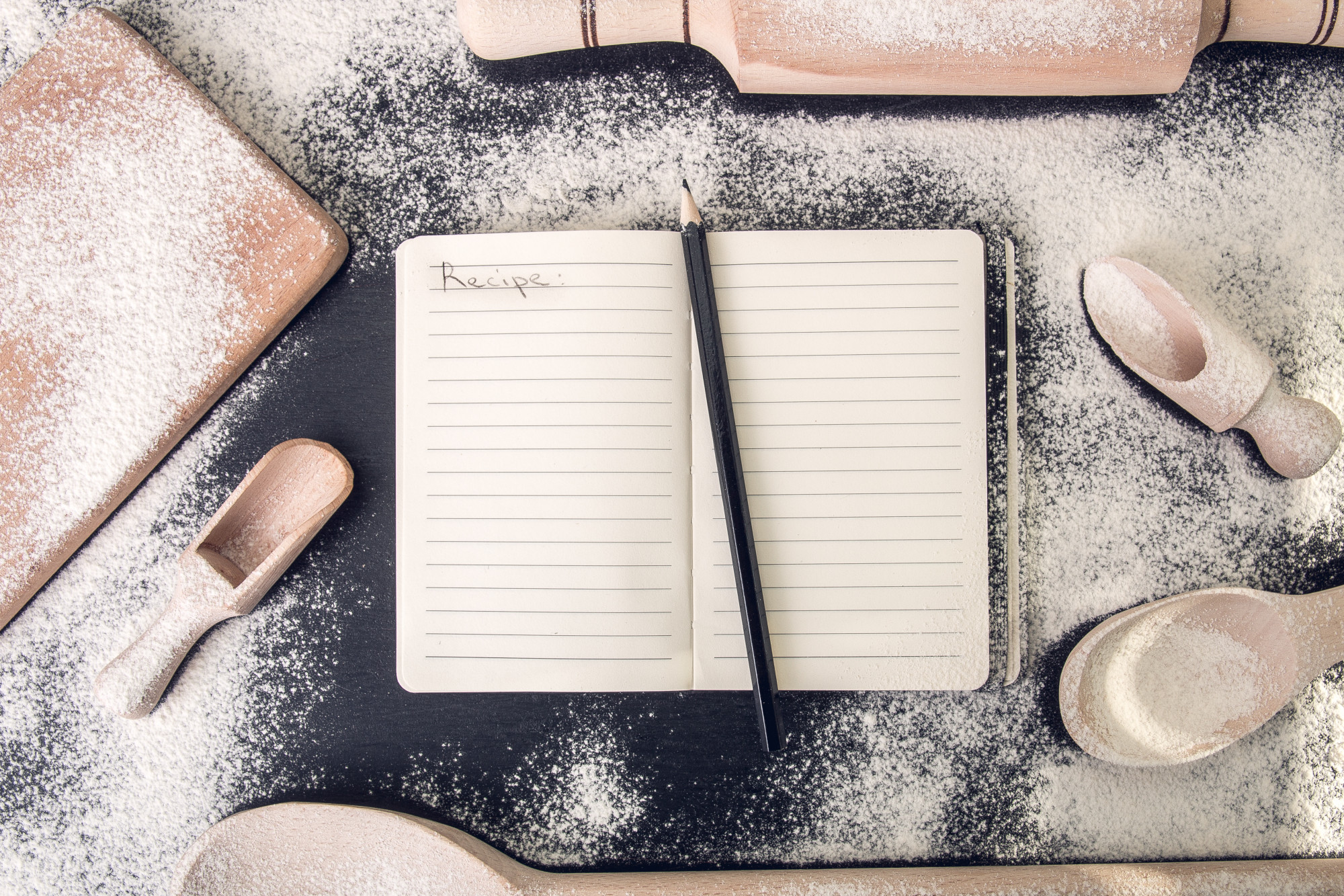 Stacked notebooks and recipe prototyping materials